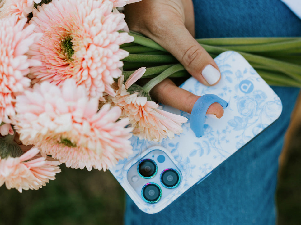 A woman holding a Blue Toile Loopy Case.