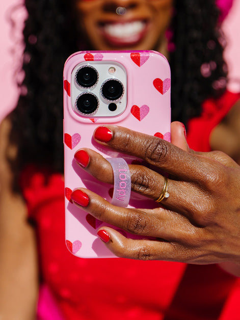 A woman holding a Sweetheart Sparkle Loopy Case.