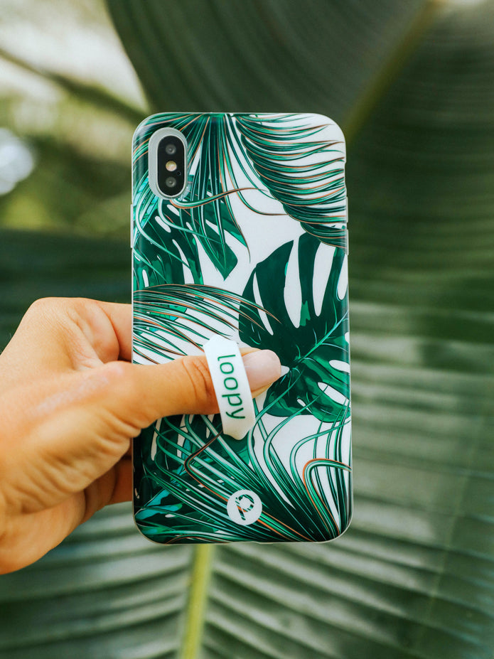 A woman holding a Monstera Loopy Case.