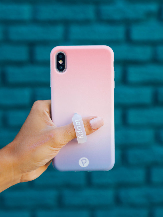 A woman holding a Sunset Loopy Case.