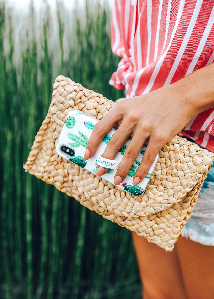 A woman holding a Cactus Loopy Case.