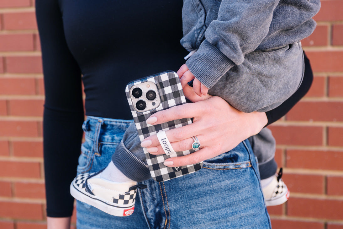 A woman holding a Plaid Loopy Case.