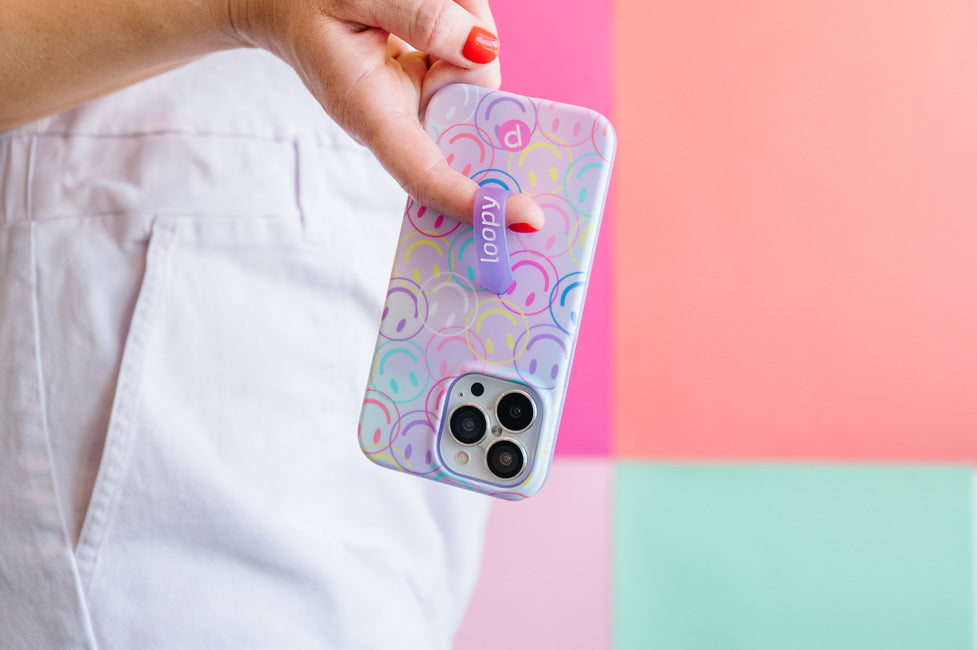 A woman holding a Smileys Loopy Case.