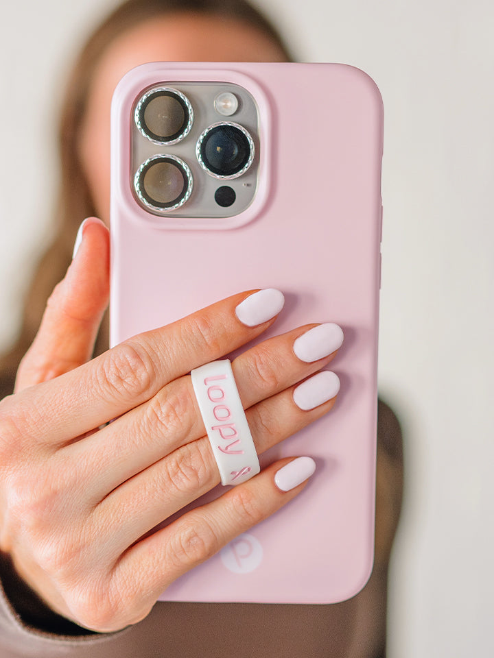 A woman holding a Blush Loopy Case.|| feature-media