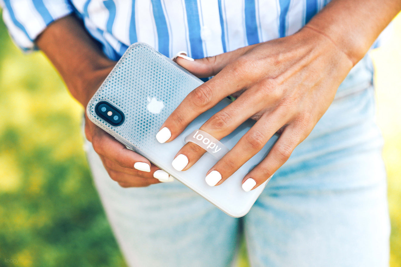 A woman holding a White Ombre Loopy Case.