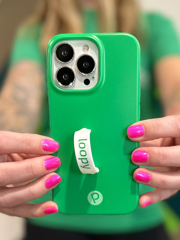 A woman holding a Loopy Green Loopy Case. || feature-media