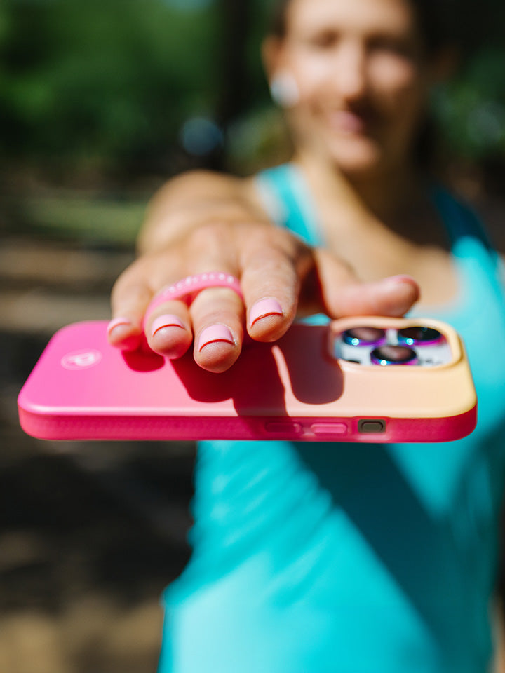 A woman holding a Pink Lemonade Ombre Loopy Case.|| feature-media