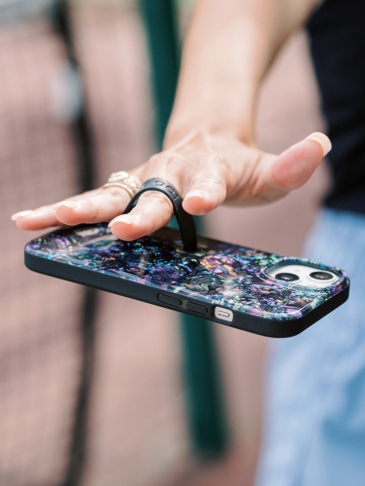 A woman holding an Abalone Loopy Case.|| feature-media