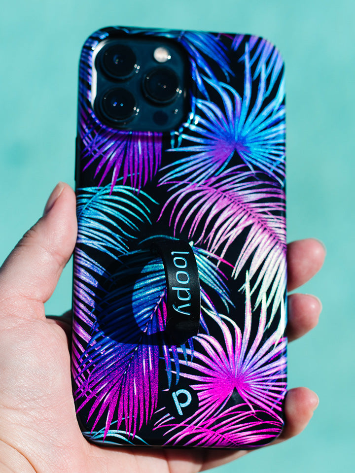 A woman holding an Aurora Palms Loopy Case. || feature-media