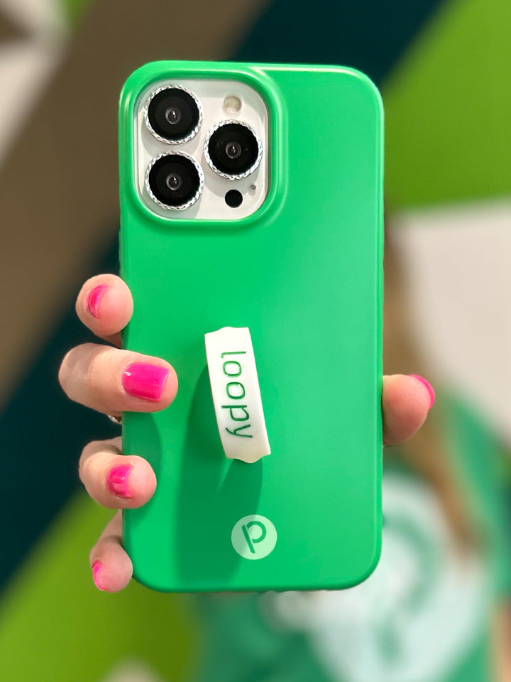 A woman holding a Loopy Green Loopy Case.