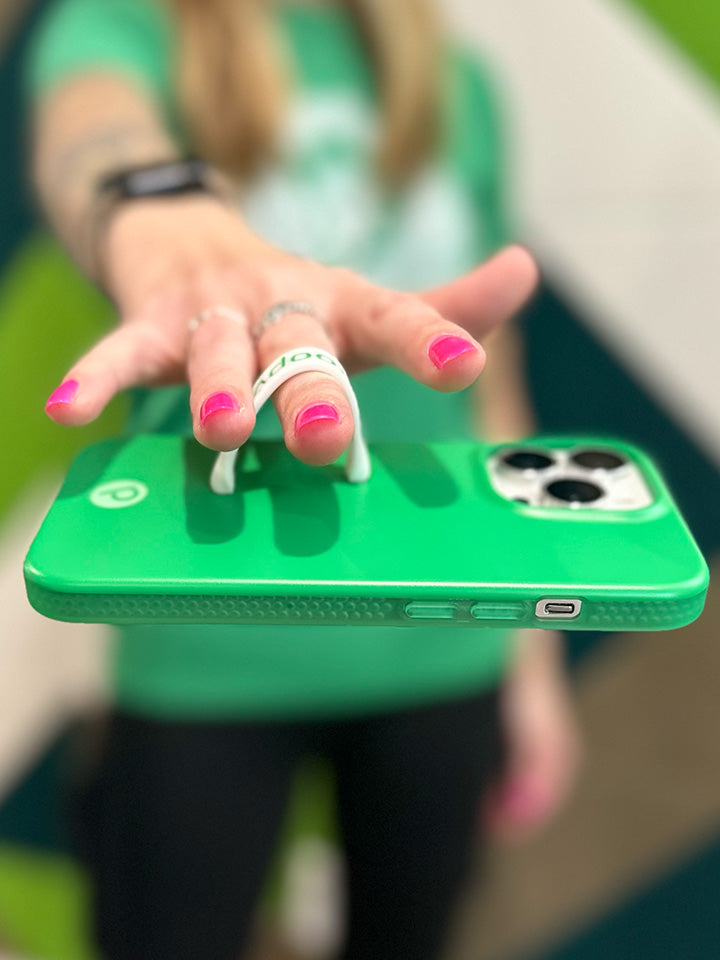 A woman holding a Loopy Green Loopy Case. || feature-media