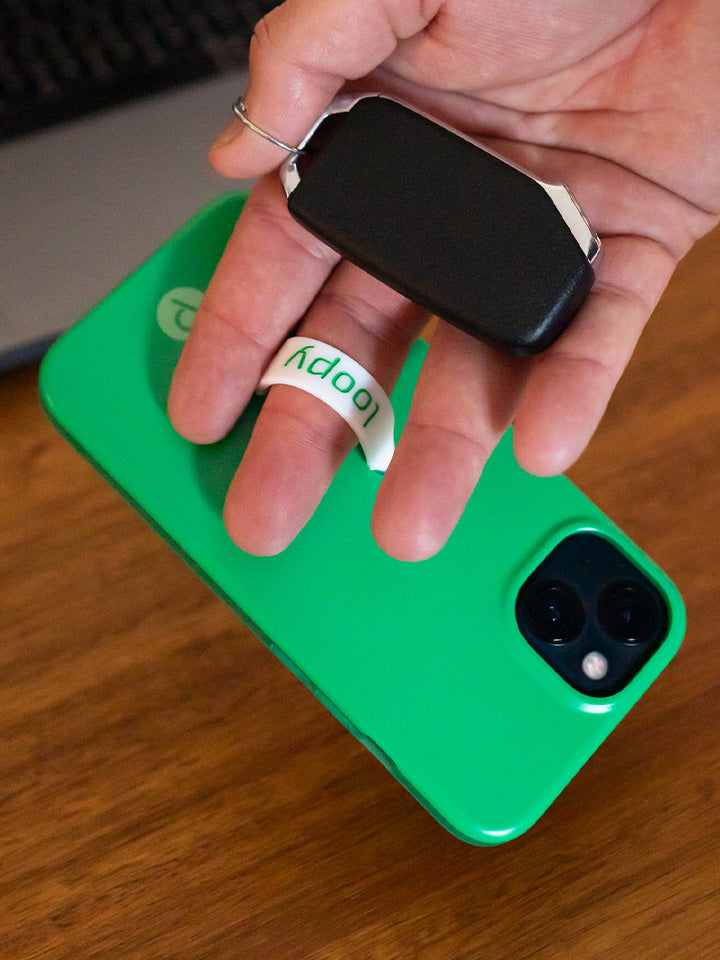 A man holding a Loopy Green Loopy Case. || feature-media