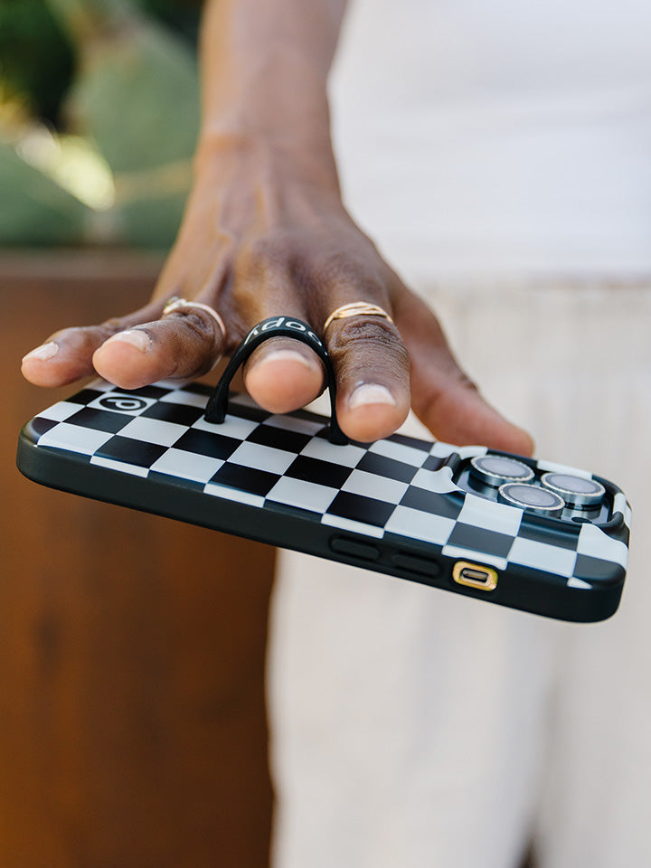  A woman holding a Black and White Checkered Loopy Case.|| feature-media