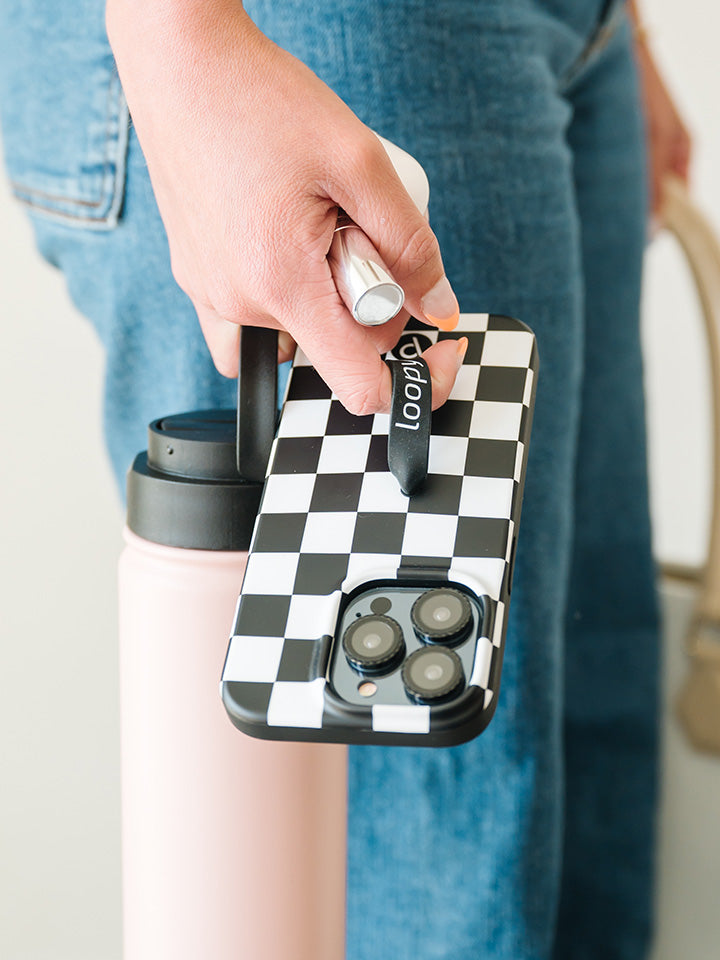  A woman holding a Black and White Checkered Loopy Case.|| feature-media