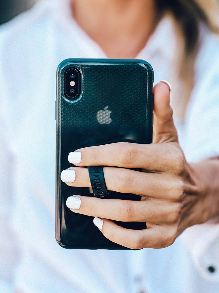 A woman holding a Black Ombre Loopy Case.|| feature-media