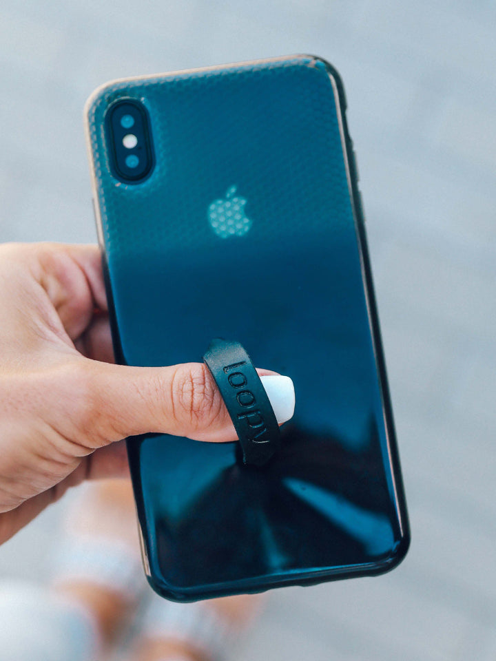 A woman holding a Black Ombre Loopy Case.|| feature-media