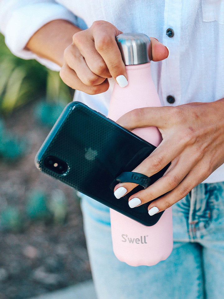 A woman holding a Black Ombre Loopy Case.|| feature-media