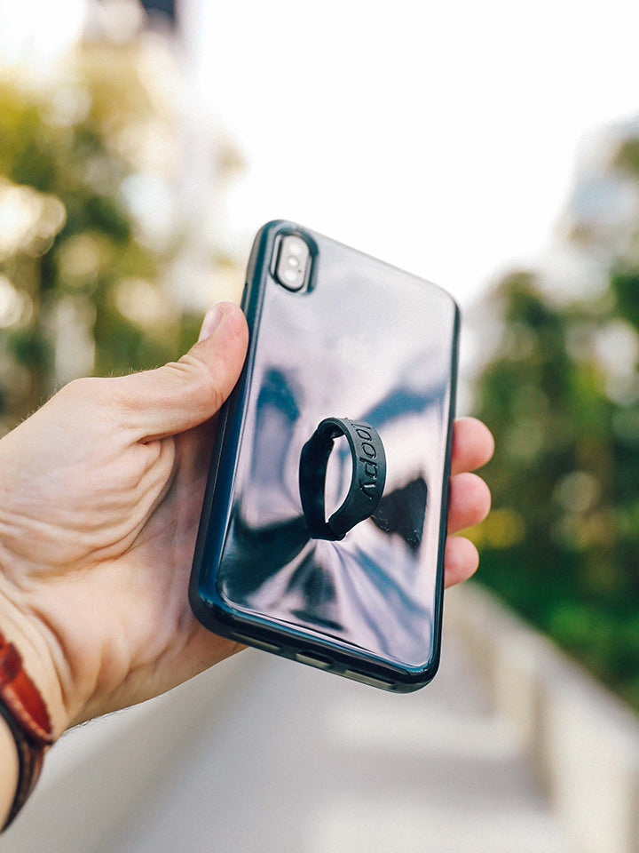 A woman holding a Black Ombre Loopy Case.|| feature-media