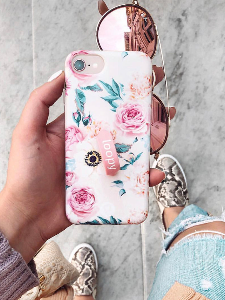 A woman holding a Blossom Loopy Case. || feature-media