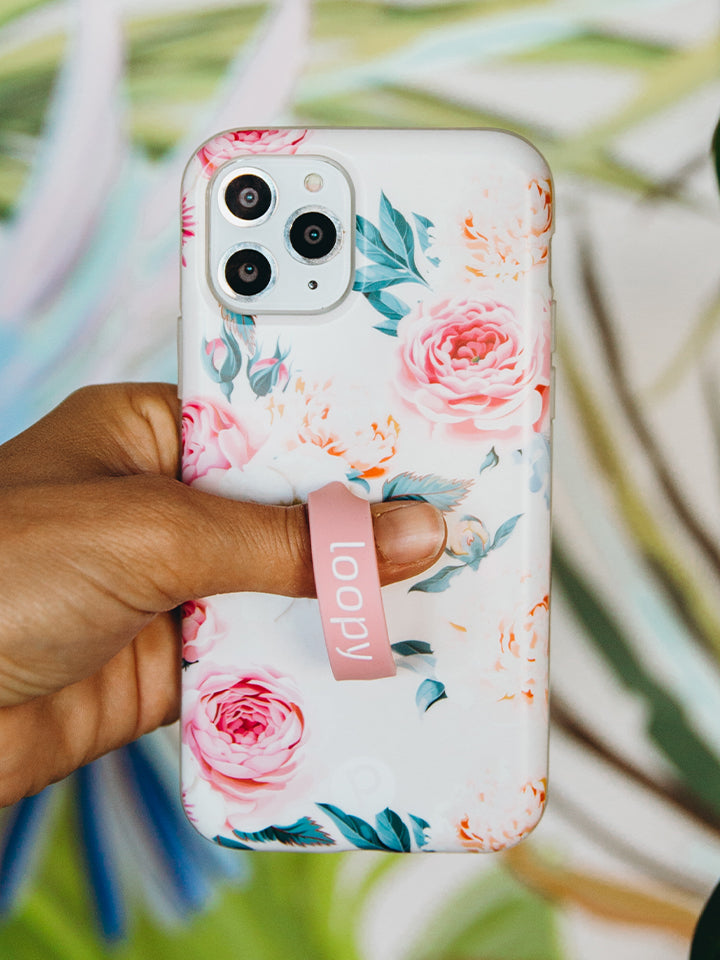 A woman holding a Blossom Loopy Case.|| feature-media