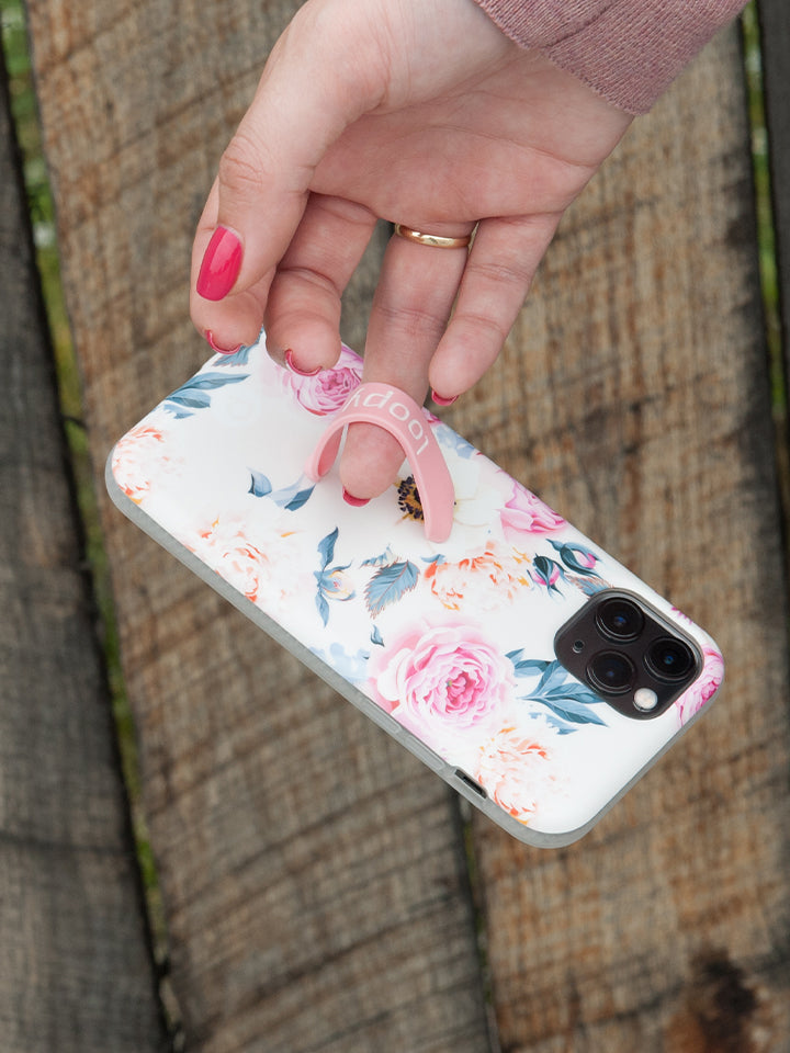 A woman holding a Blossom Loopy Case. || feature-media