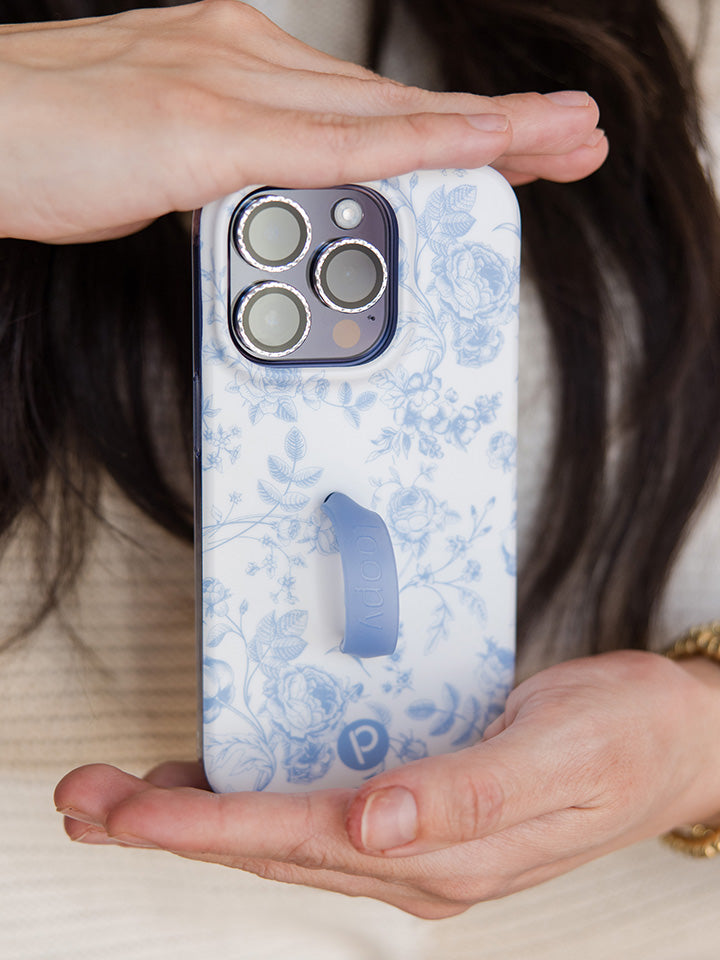 A woman holding a Blue Toile Loopy Case. || feature-media