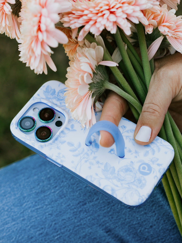 A woman holding a Blue Toile Loopy Case. || feature-media