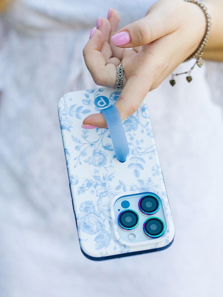 A woman holding a Blue Toile Loopy Case. || feature-media