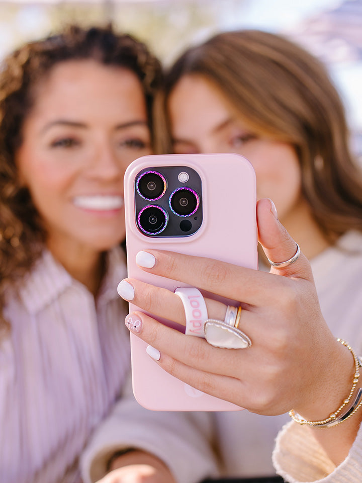 Two women taking a selfie while one woman is holding a Blush Loopy Case.|| feature-media