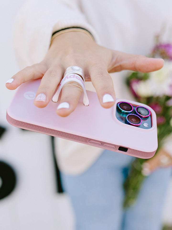 A woman holding a Blush Loopy Case.|| feature-media