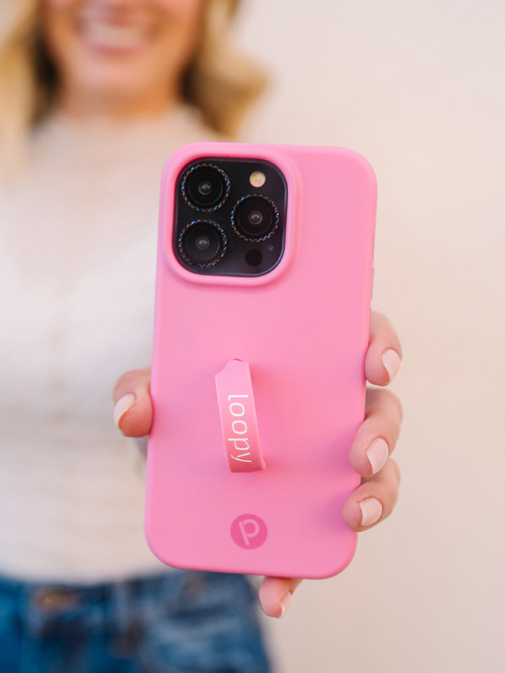 A woman holding a Bubblegum Pink Loopy Case.|| feature-media