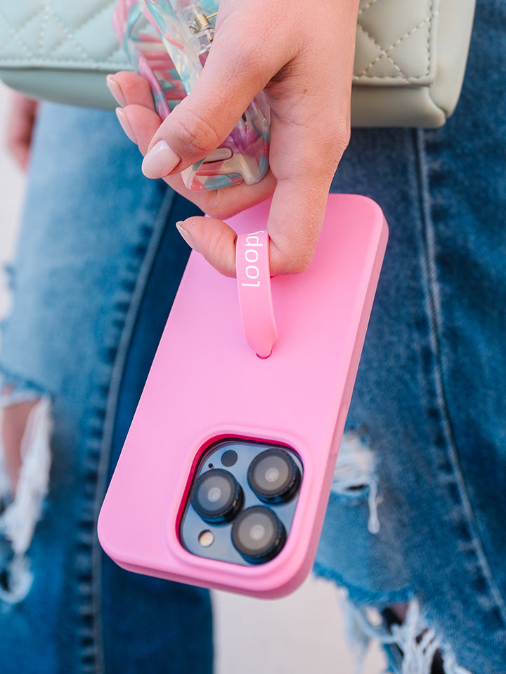 A woman holding a Bubblegum Pink Loopy Case.|| feature-media