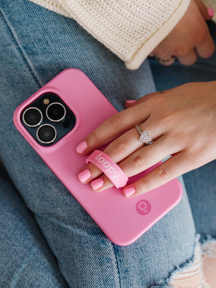 A woman holding a Bubblegum Pink Loopy Case.|| feature-media