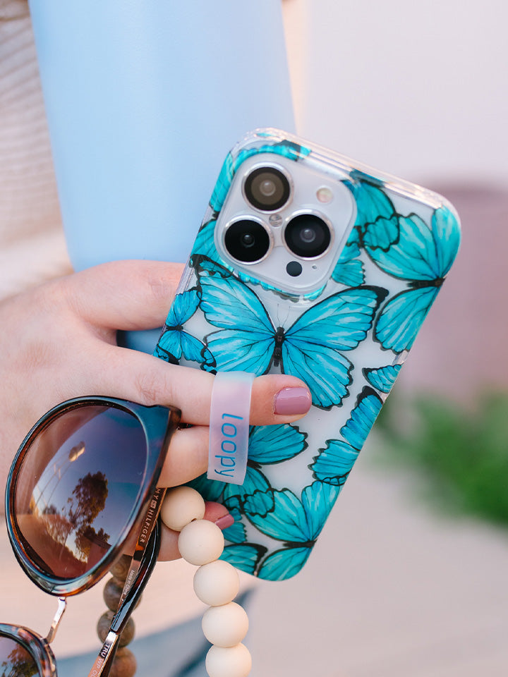 A woman holding a Butterflies Loopy Case. || feature-media