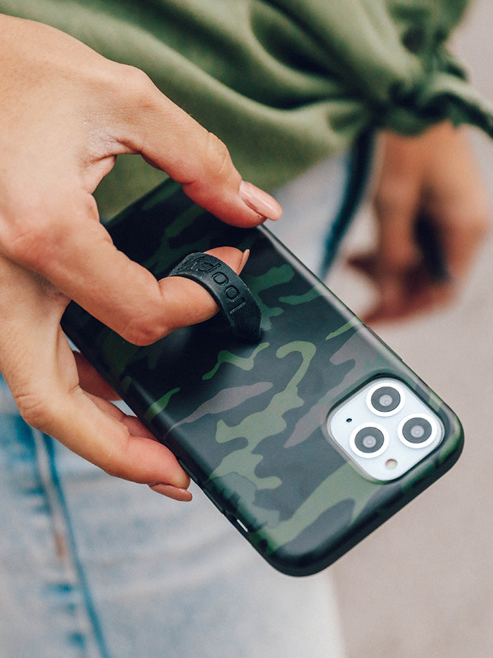 A woman holding a Camo Loopy Case.|| feature-media