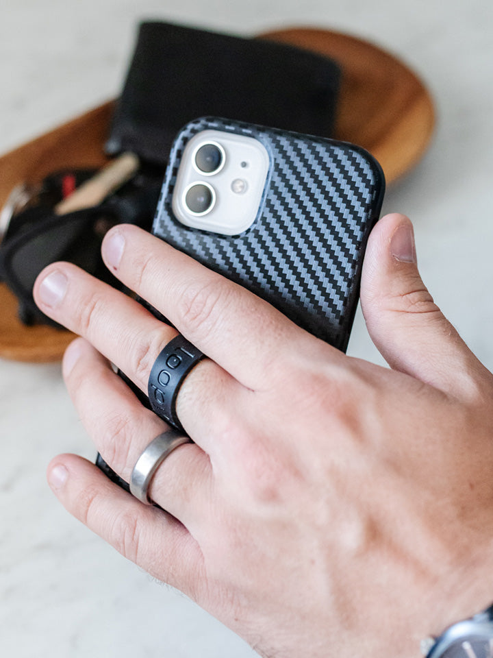 A man holding a Carbon Loopy Case.|| feature-media