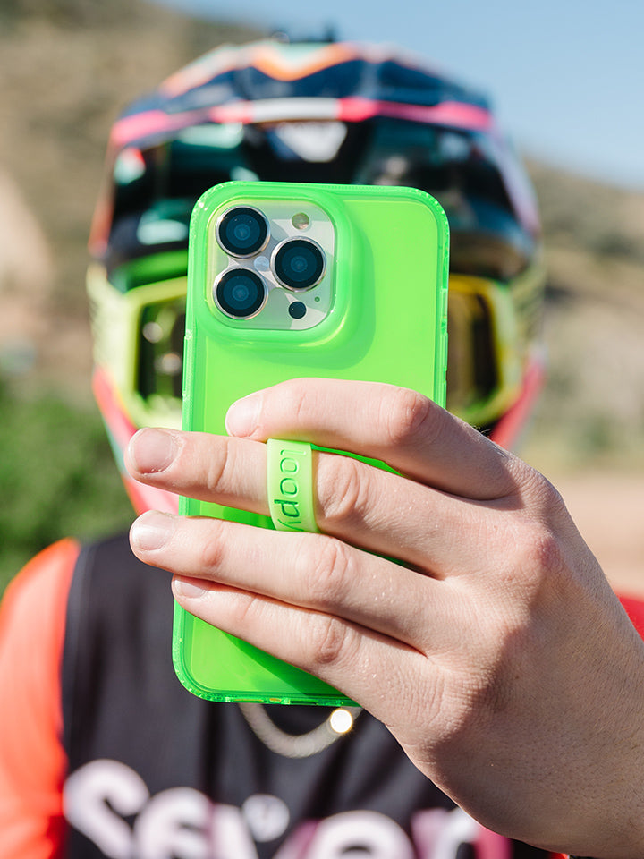 A man holding a Clear Neon Green Loopy Case.|| feature-media