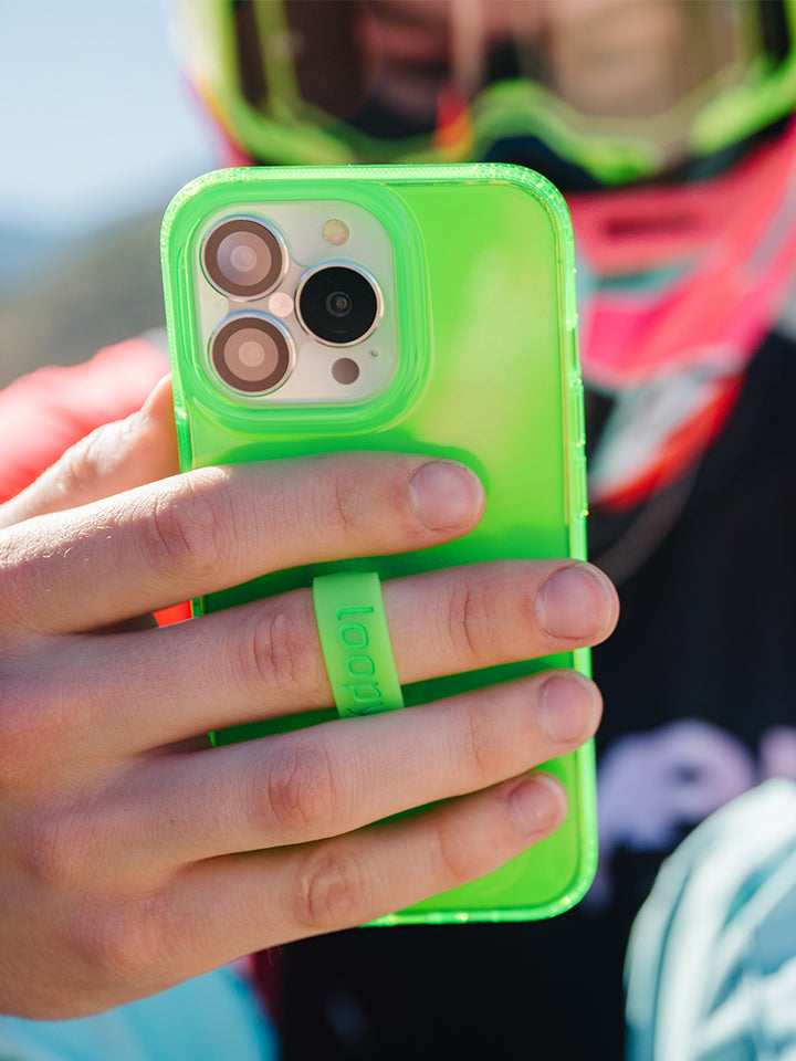 A man holding a Clear Neon Green Loopy Case.|| feature-media