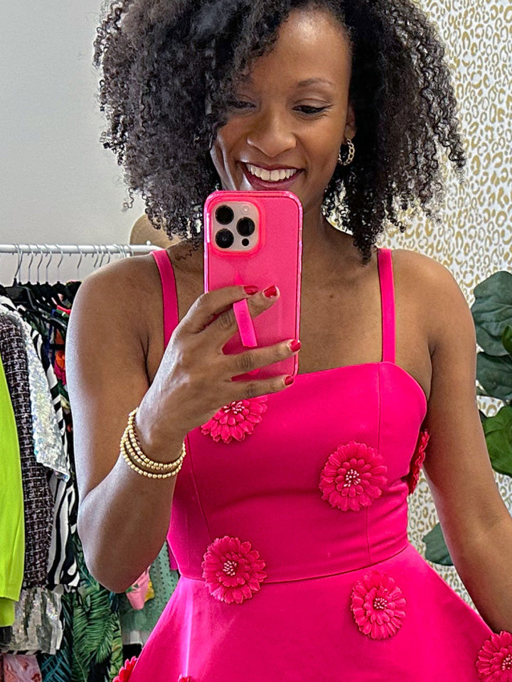 A woman holding a Clear Neon Pink Loopy Case.|| feature-media