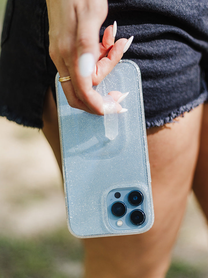 A woman holding a Clear Sparkle Silver Loopy Case. || feature-media