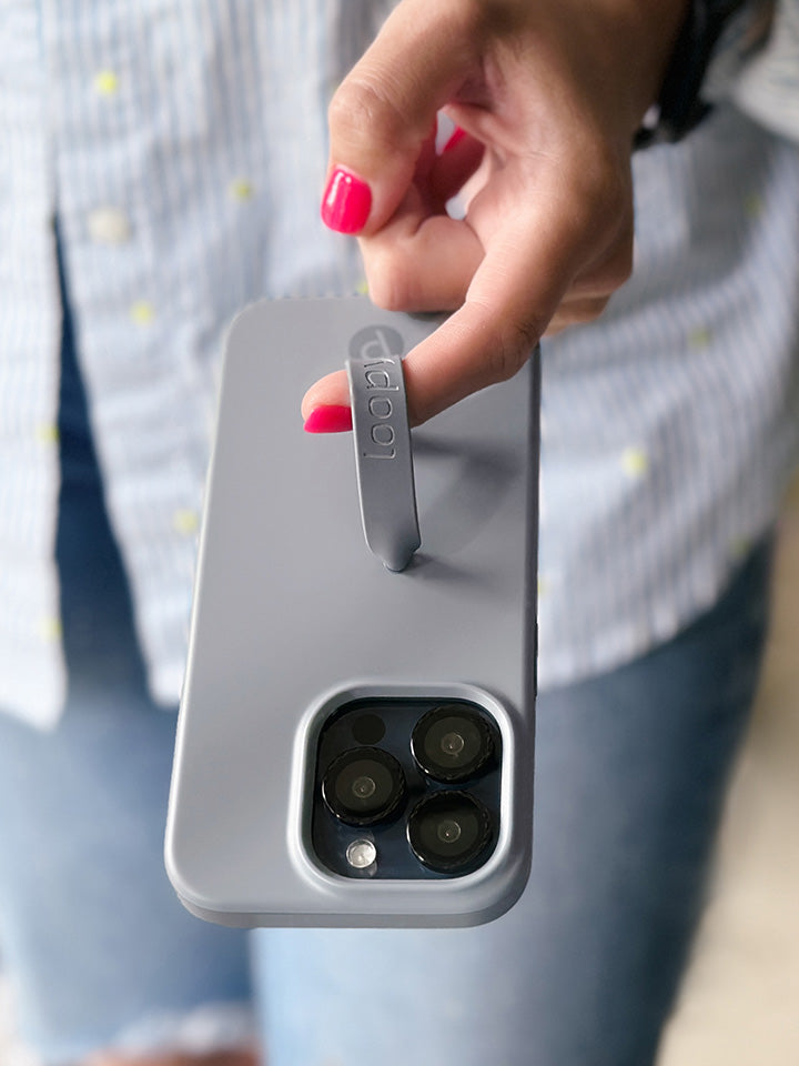 A woman holding a Cool Gray Loopy Case.|| feature-media