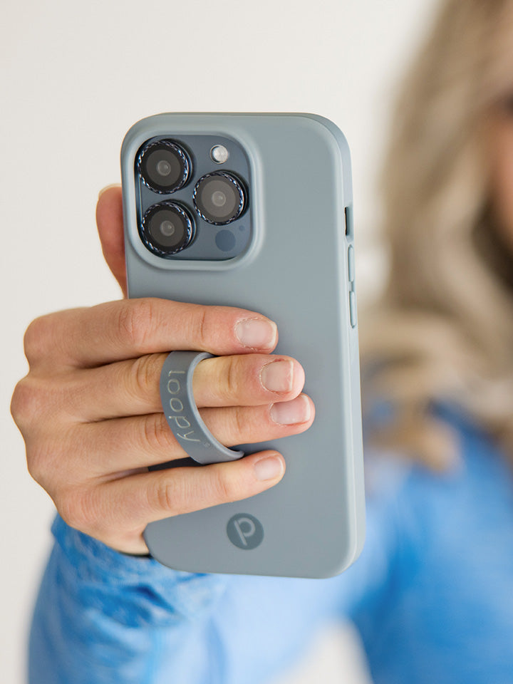 A woman holding a Cool Gray Loopy Case.|| feature-media