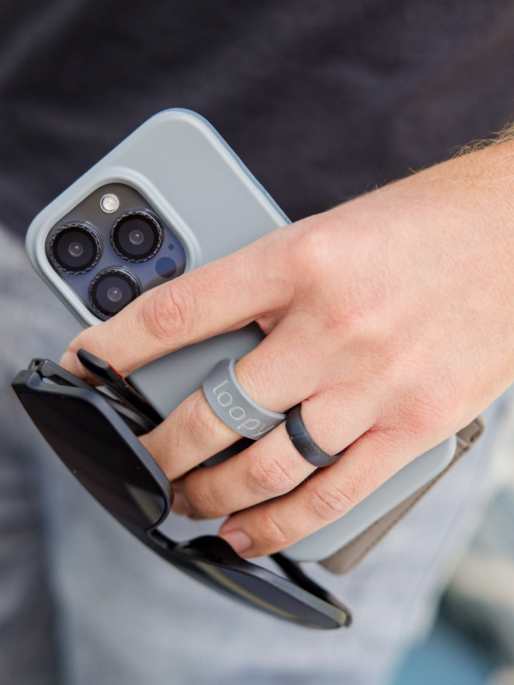 A man holding a Cool Gray Loopy Case.|| feature-media