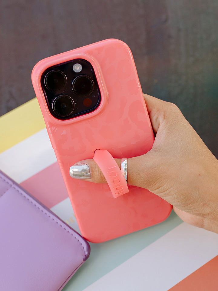 A woman holding a Coral Loopy Case.|| feature-media