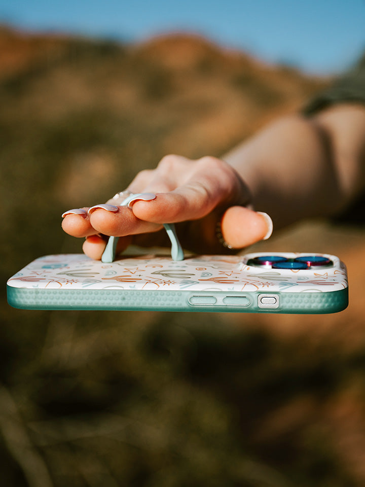 A woman holding a Desert Bliss Loopy Case.|| feature-media