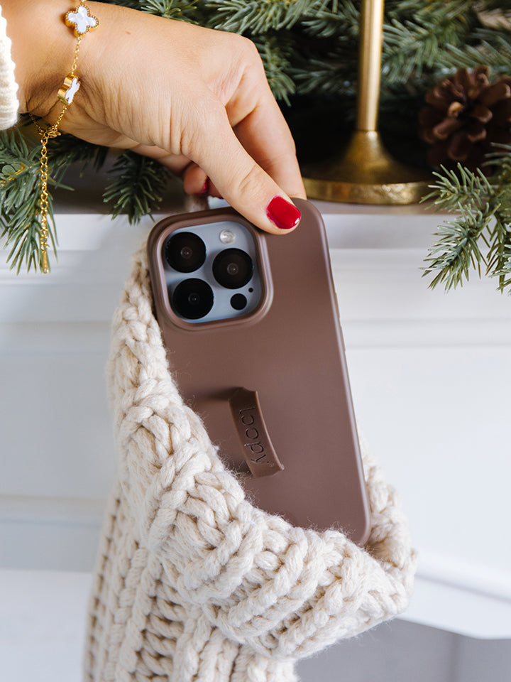 A woman holding an Espresso Loopy Case. || feature-media