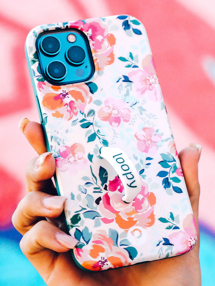 A woman holding a Gardenia Loopy Case. || feature-media