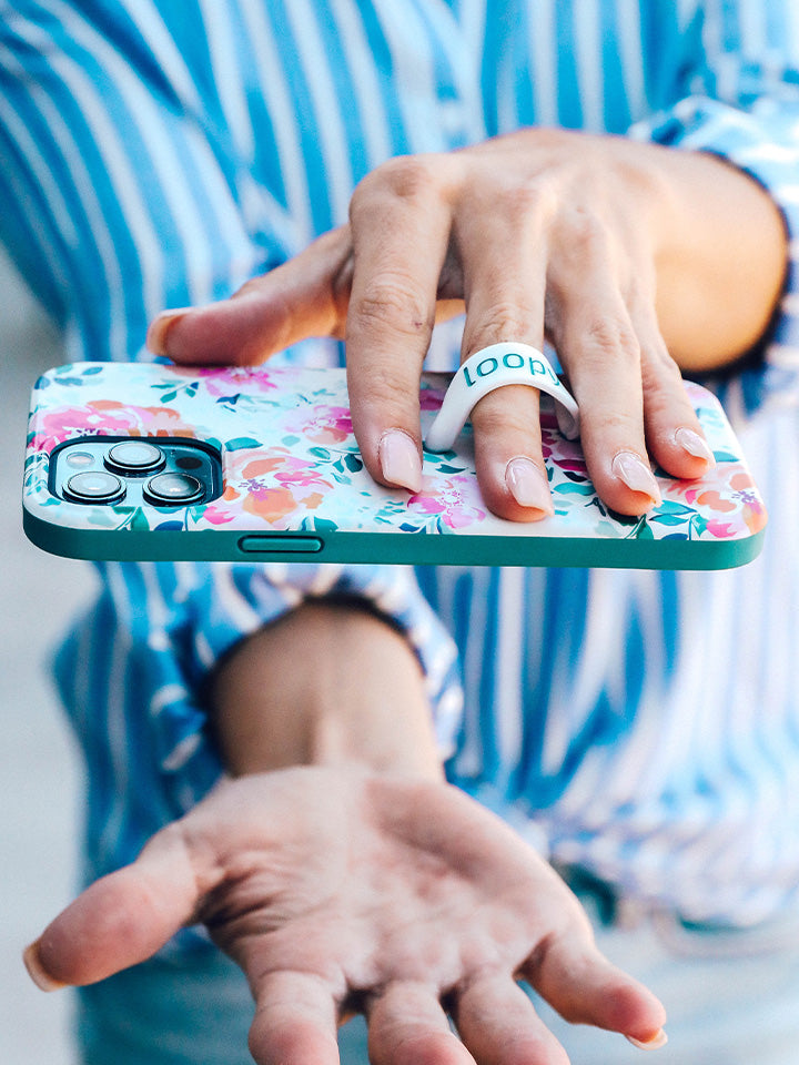 A woman holding a Gardenia Loopy Case. || feature-media