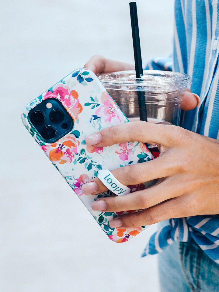 A woman holding a Gardenia Loopy Case. || feature-media