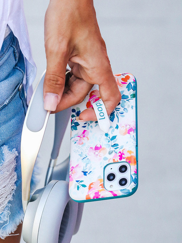 A woman holding a Gardenia Loopy Case. || feature-media